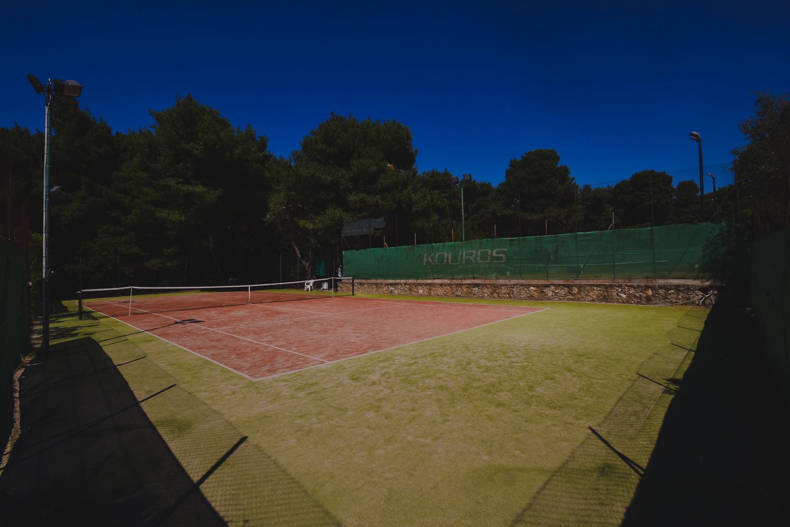 Clay court from the baseline, deep in the pine woods